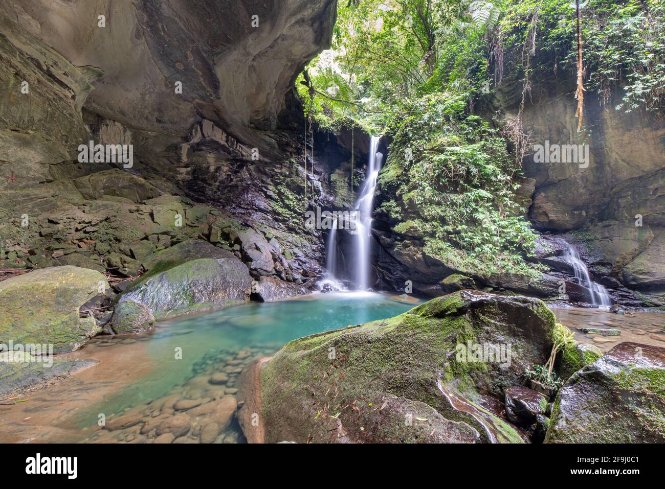 Waterfall among the rocks of blue water Stock Photo - Alamy