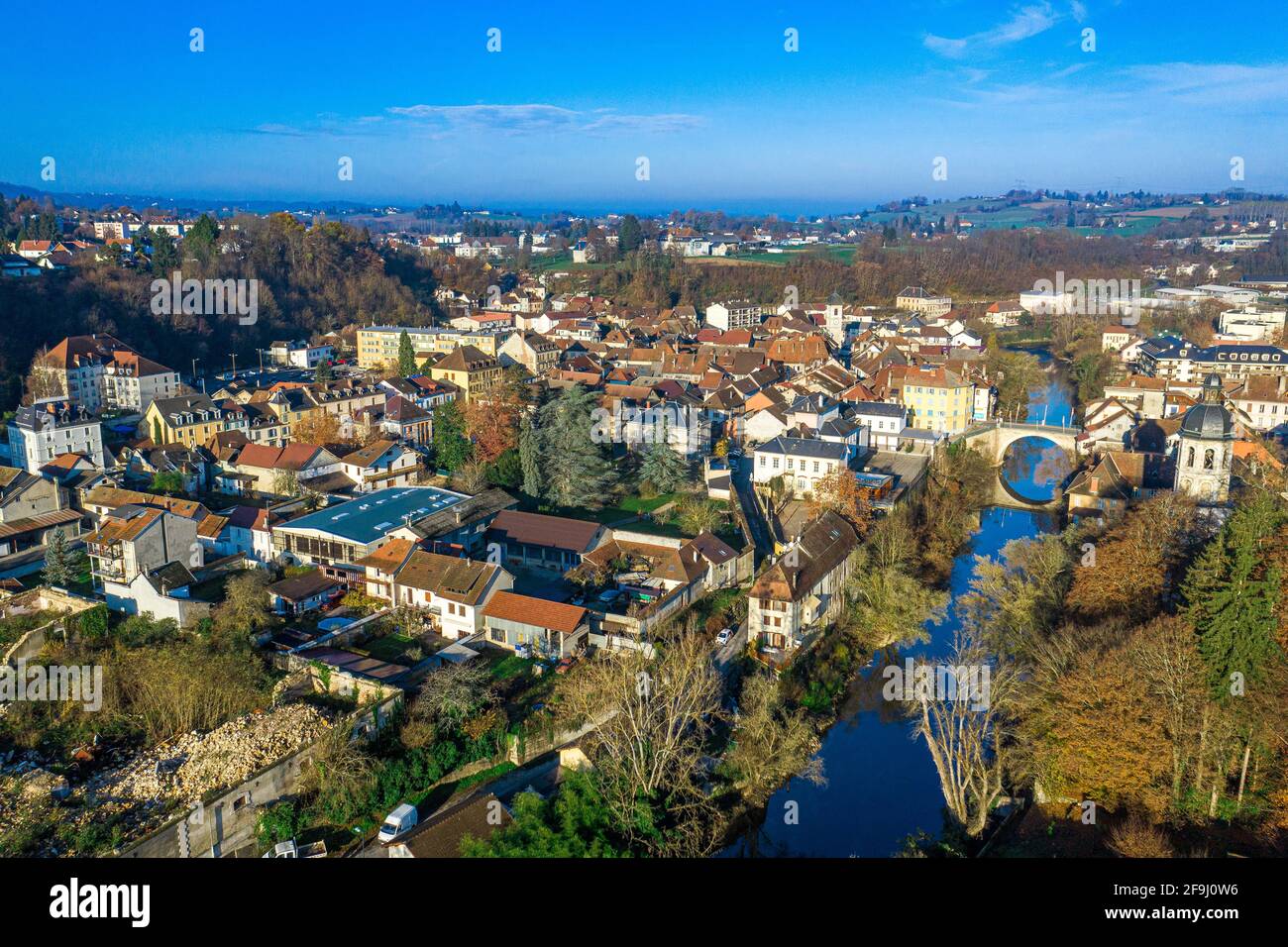 Aerial shot of a small town under the vast blue sky taken using a drone. Stock Photo