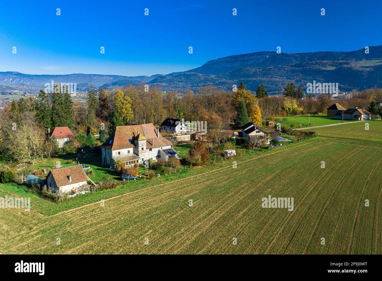 Aerial drone view of a small town located in front of the mighty alps ...