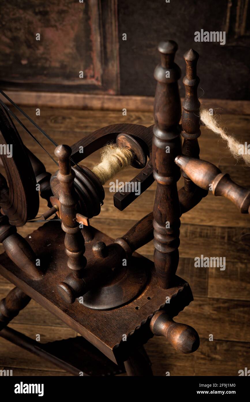 Still life image of an authentic old spinning wheel with real sheep wool Stock Photo