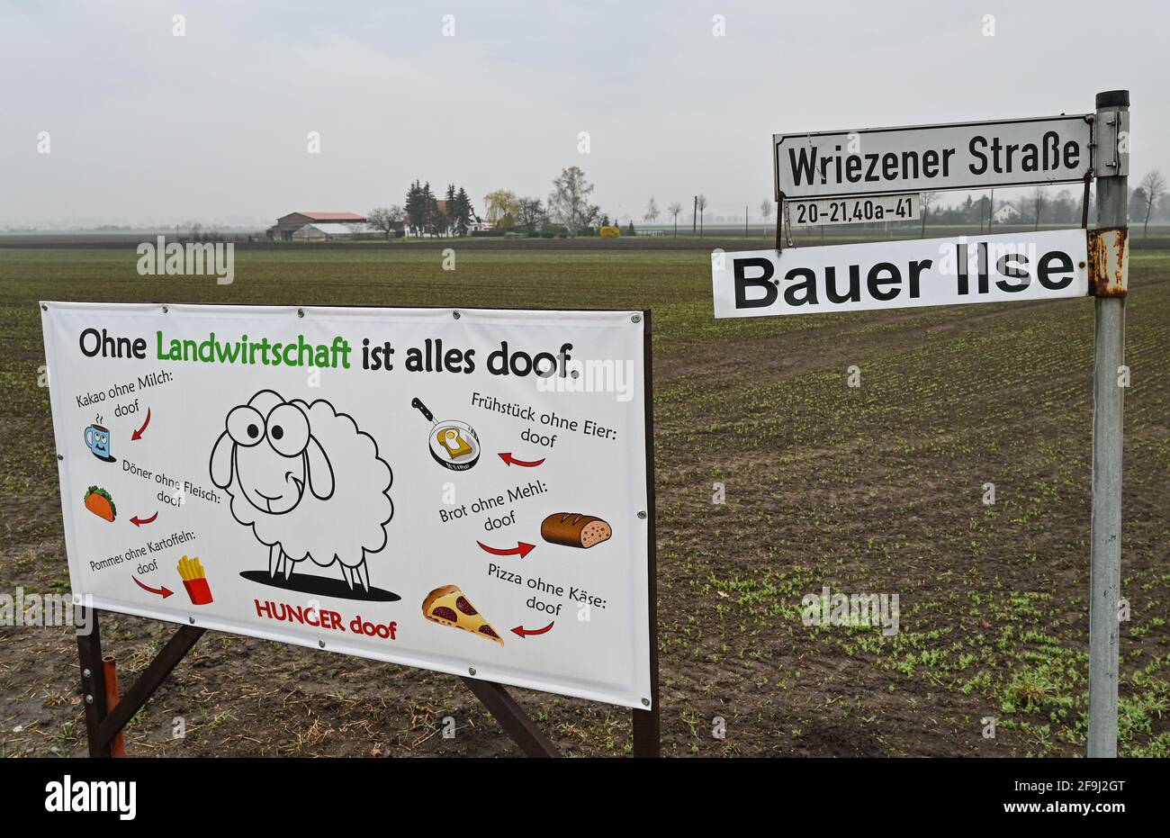 19 April 2021, Brandenburg, Letschin: A poster with the inscription 'Ohne Landwirtschaft ist alles doof' (Without farming, everything is stupid) stands at the entrance to farmer Ilse's farm. Due to the problematic situation for pig farmers in the ASF restriction zones, farmer Karsten Ilse has given up his fattening pig farming after 24 years. This morning Ilse, as one of the few pig farmers in the district of Märkisch-Oderland, loaded his last 36 fattening pigs and sent them on their last journey to Kellinghusen. The slaughterhouse in Schleswig-Holstein is the only one willing to slaughter dom Stock Photo