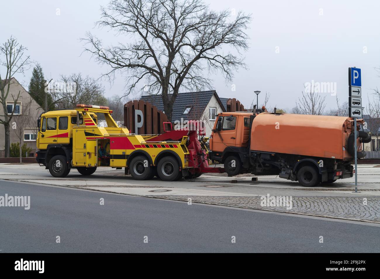 A street cleaning sweeper is towed away Stock Photo