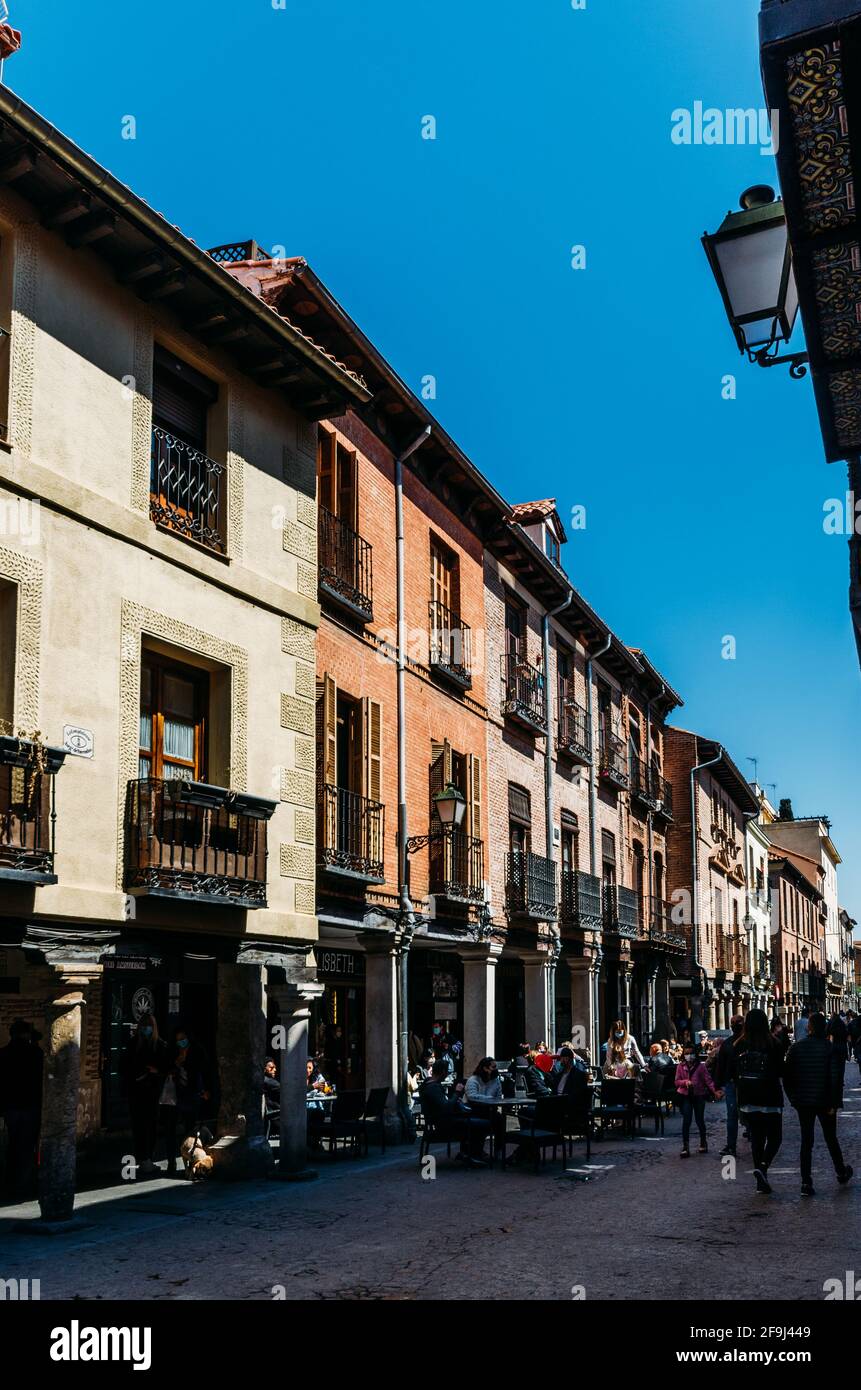 Main street (Calle Mayor) with curious buildings, street cafes and people Stock Photo