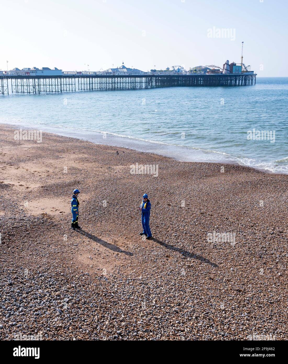 Brighton UK 19th April 2021 - HM Coastguard check Brighton beach early this morning after a suspected unexploded WW2 mortar was discovered yesterday . The beach and seafront are now back open after being evacuated on Sunday afternoon  :  Credit Simon Dack / Alamy Live News Stock Photo