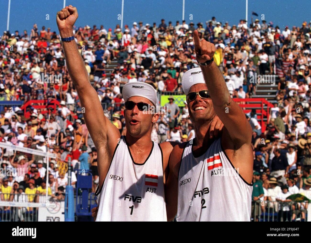 OLIVER STAMM AND NIKOLAS BERGER OF AUSTRIA, SEP 2000CELEBRATE AFTER BEATING AUSTRALIA IN THE MENS BEACH VOLLEYBALL AT THE SYDNEY OLYMPIC GAMES. Stock Photo