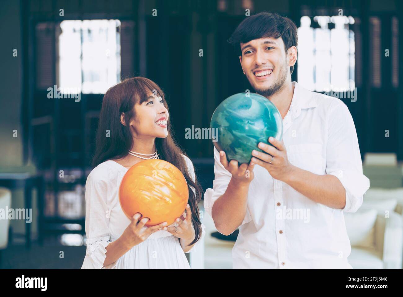 Young couple playing bowling at the club. Sport and recreation lifestyle. Stock Photo