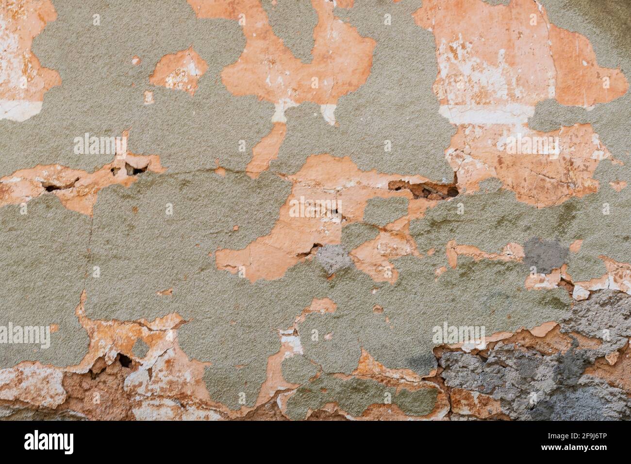 Old gray plastered wall with cracked paint. Background, texture. Stock Photo