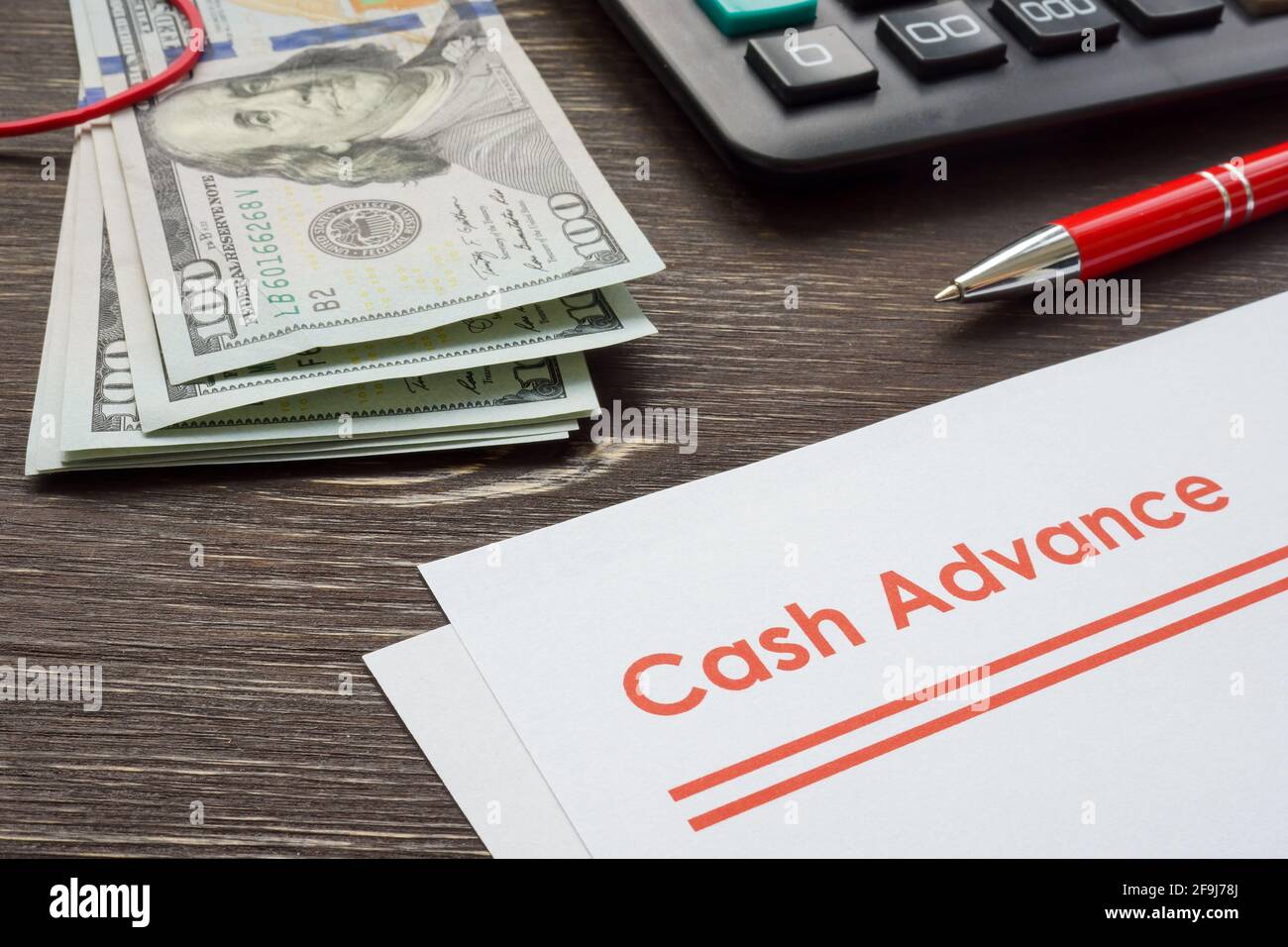 Papers for cash advance with calculator and money. Stock Photo