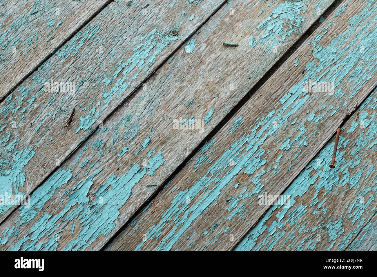 Old turquoise wooden board with rusty hobnails. vintage background Stock Photo