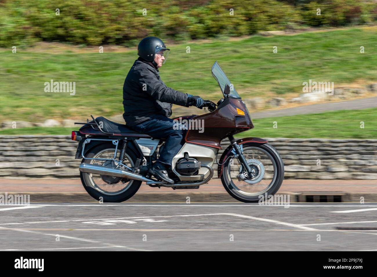 BMW R100RT Classic motorcycle, motorcyclist riding in Southend on Sea, Essex, UK, on a sunny, bright Spring day. Stock Photo