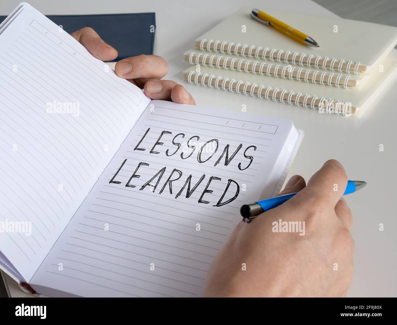 Lessons learned concept. The man made a diary entry. Stock Photo