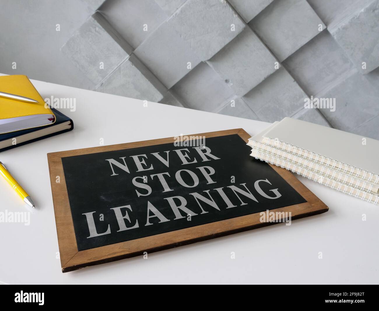 Never stop learning on the blackboard about lifelong education. Stock Photo