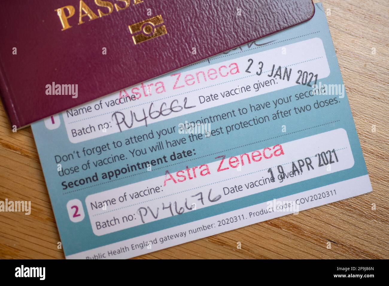 London, UK. 19 April 2021. Vaccine certificate issued by NHS UK with second Astra Zeneca vaccination stamped, certificate tucked inside UK passport. Credit: Malcolm Park/Alamy Live News. Stock Photo