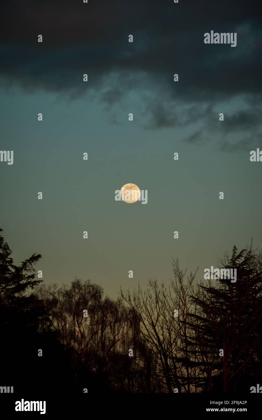 Full moon in horizon of dramatic night sky Stock Photo - Alamy