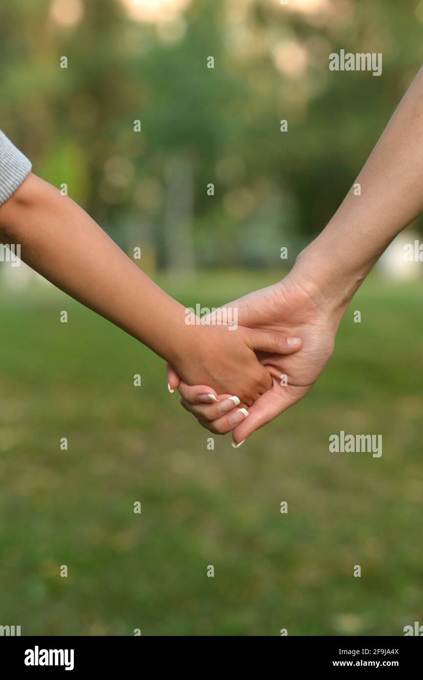 Portrait of daughter and mother holding hands Stock Photo - Alamy