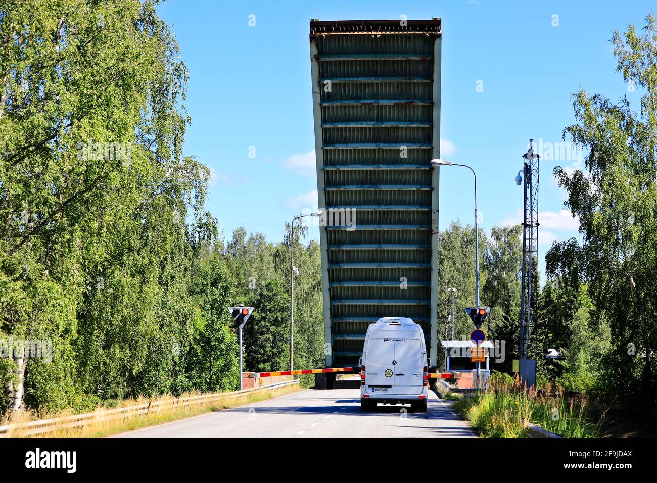 Raised lift bridge with a van waiting at Strömma canal, on the border of the municipalities of Kimitoön and Salo, Finland. August 1, 2020. Stock Photo