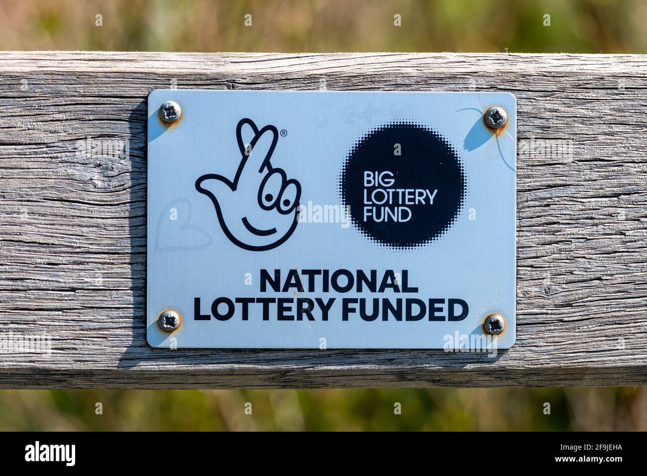 National lottery funded, big lottery fund, plaque on a wooden bench in Tices Meadow nature reserve, Surrey, UK Stock Photo