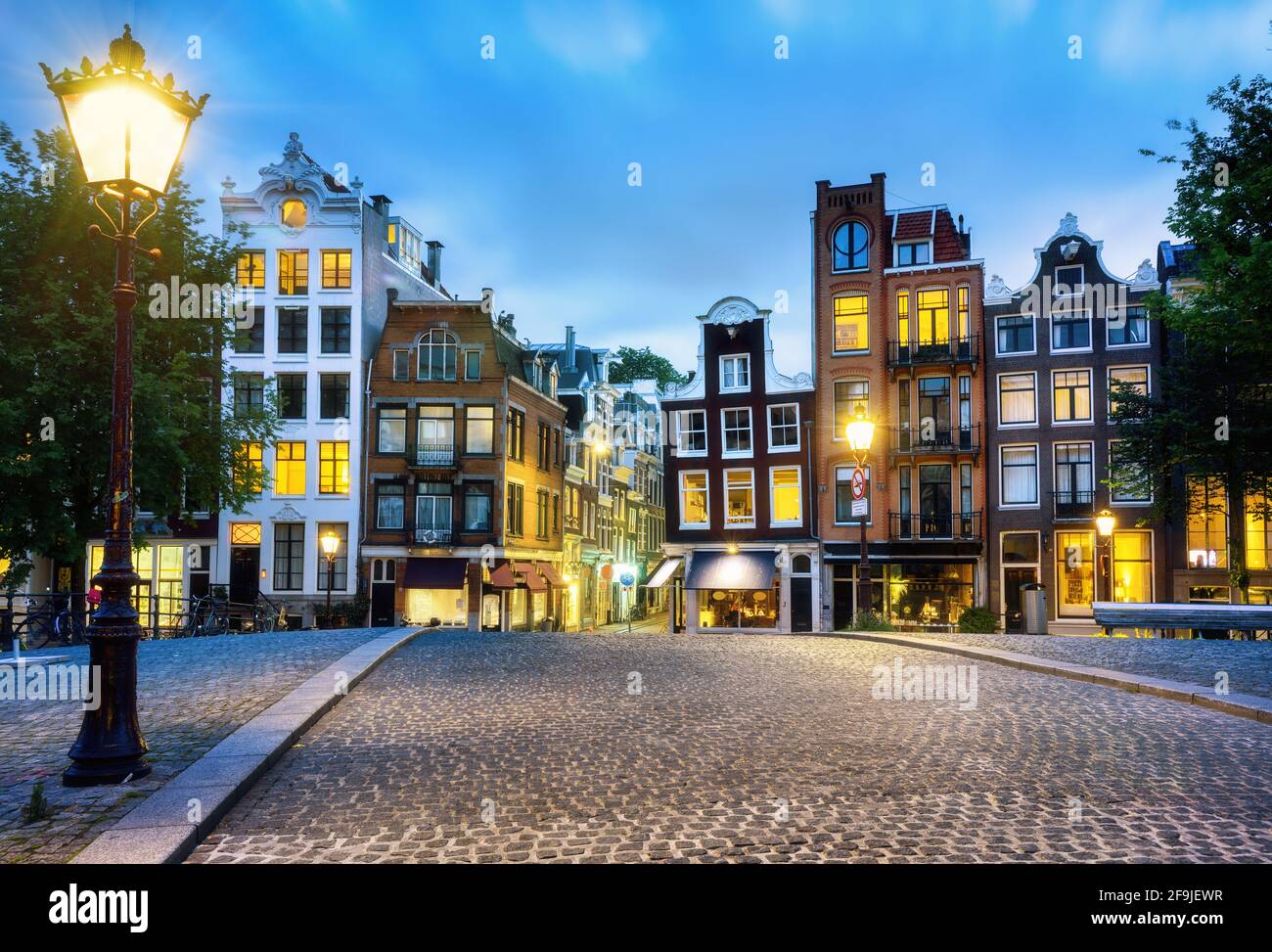 Amsterdam city, historical brick houses in the Old town center in evening light, North Holland, Netherlands Stock Photo
