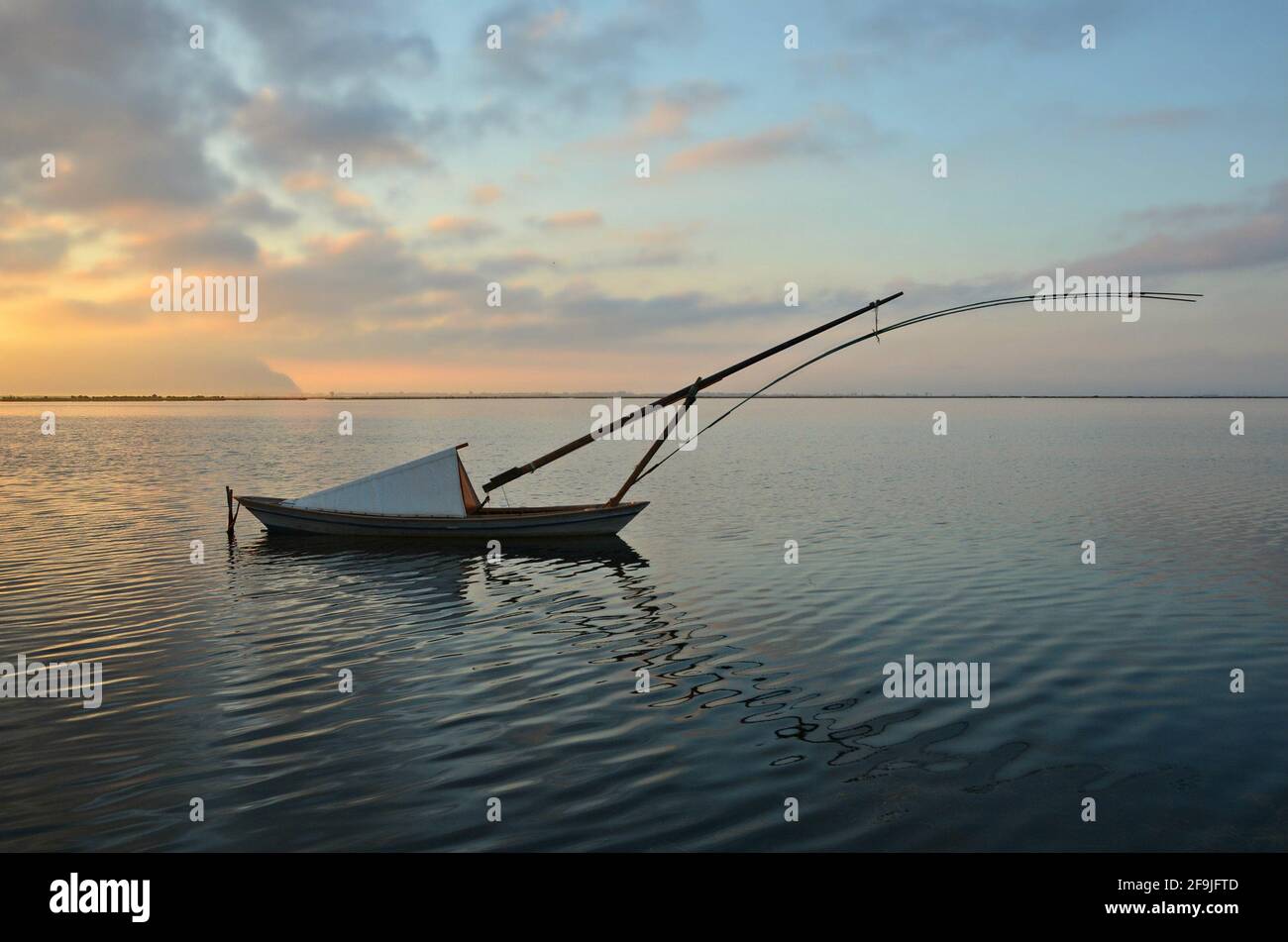 Sunrise landscape with a traditional Gaita fishing boat on the waters of Missolonghi lake in Aetolia-Acarnania, Greece. Stock Photo