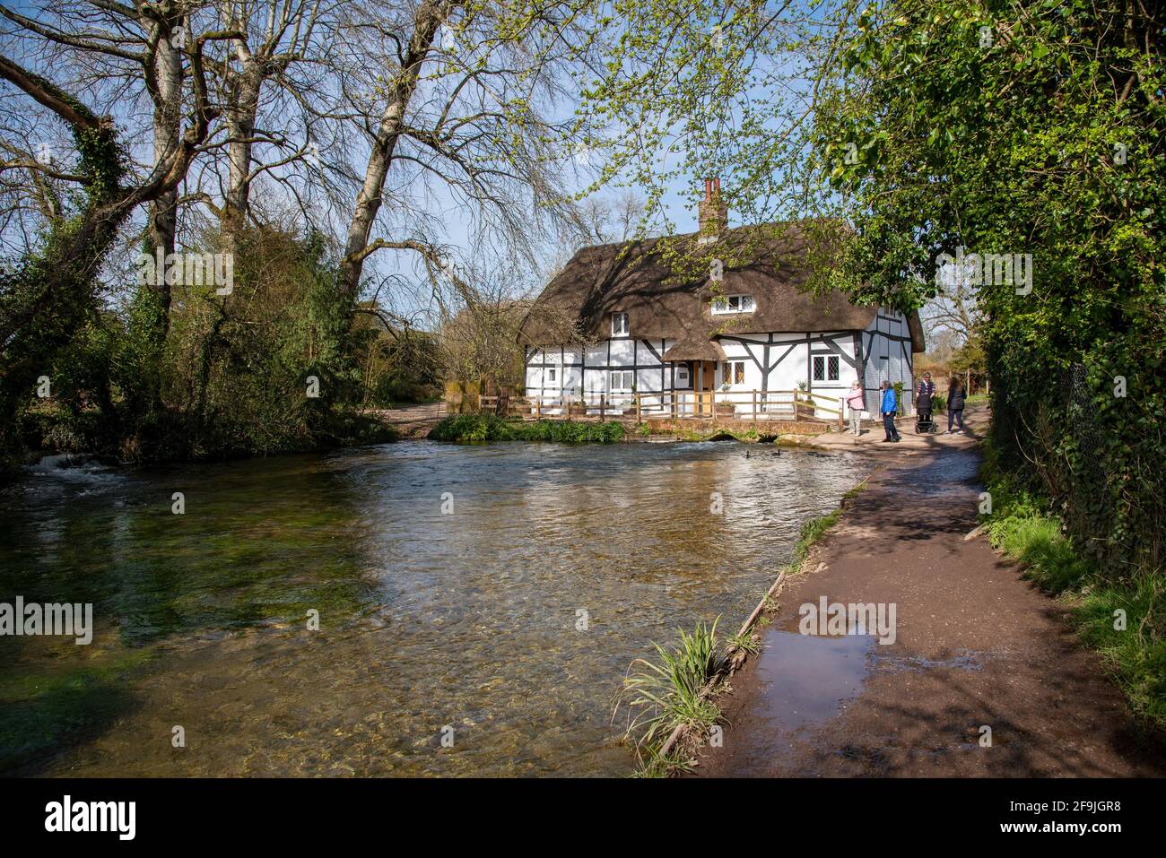 Alresford, Hampshire, England, UK. 2021,  The Fulling Mill a historic thatched building with the fast flowing River Arle passing below the ancient mil Stock Photo