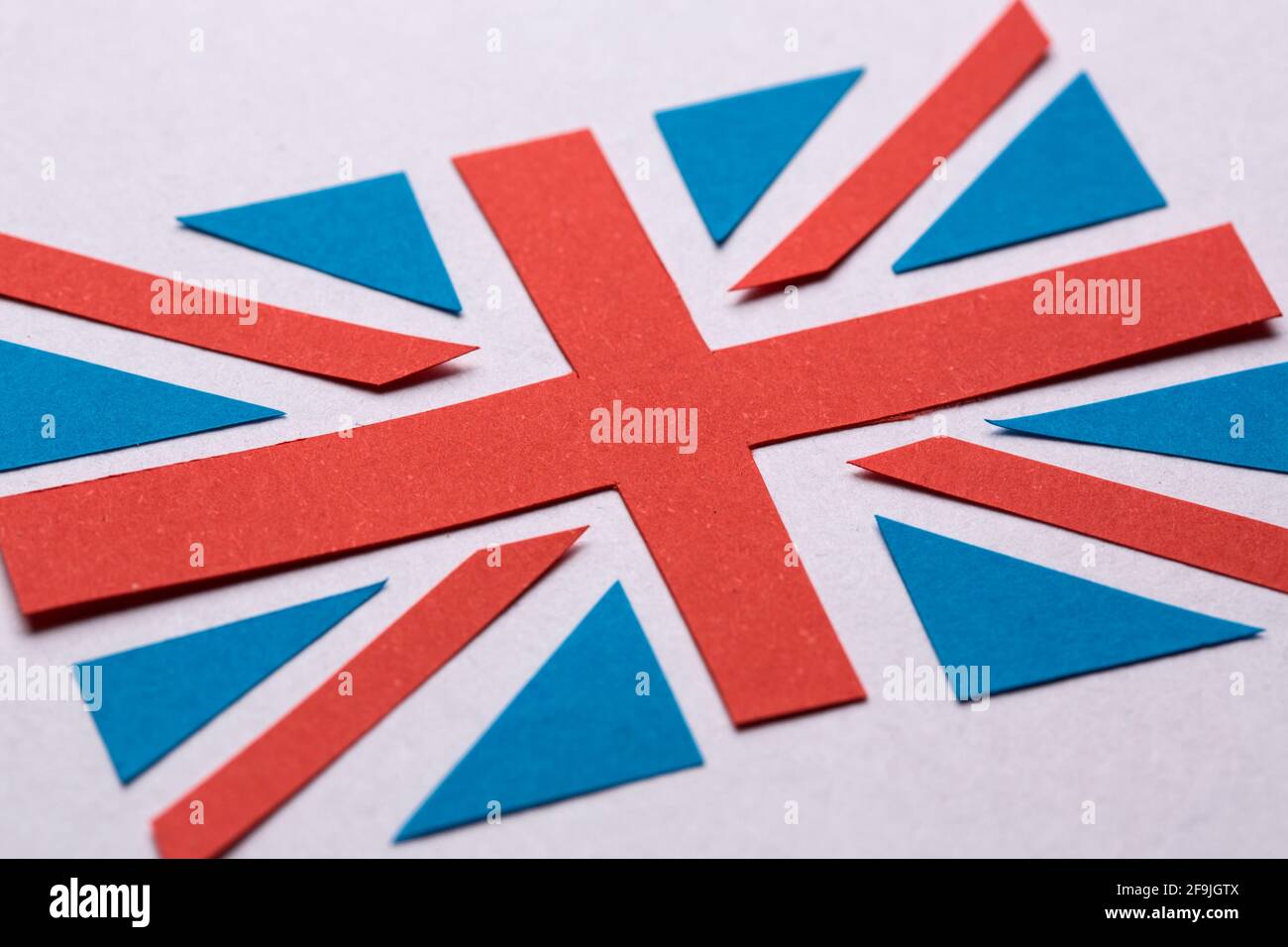 The flag of Great Britain cut out from the blue and red paper. Stock Photo