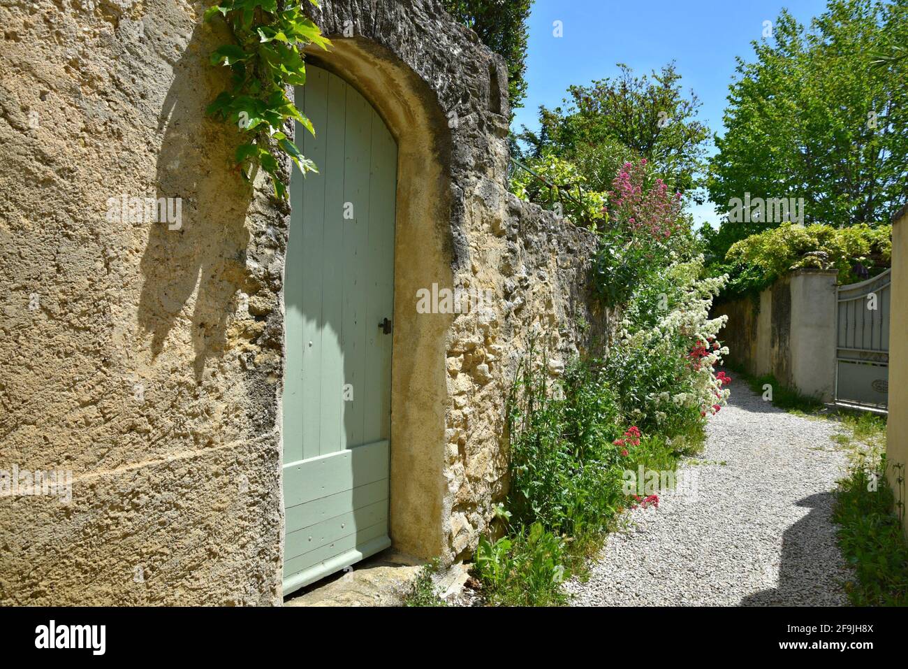 Alley with typical Provençal style architecture in the picturesque village of Lourmarin in Vaucluse, Provence France. Stock Photo