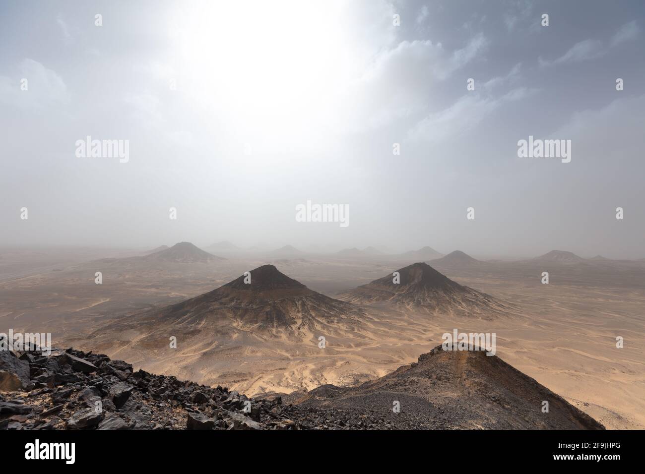 Mysterious landscape of the Black Desert with cloudy sky. Stock Photo