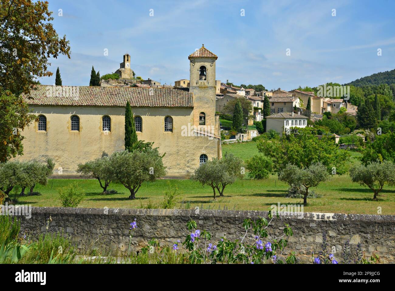 Landscape with scenic view of the Protestant Temple and Provençal style rural houses in the picturesque village of Lourmarin Vaucluse Provence France. Stock Photo