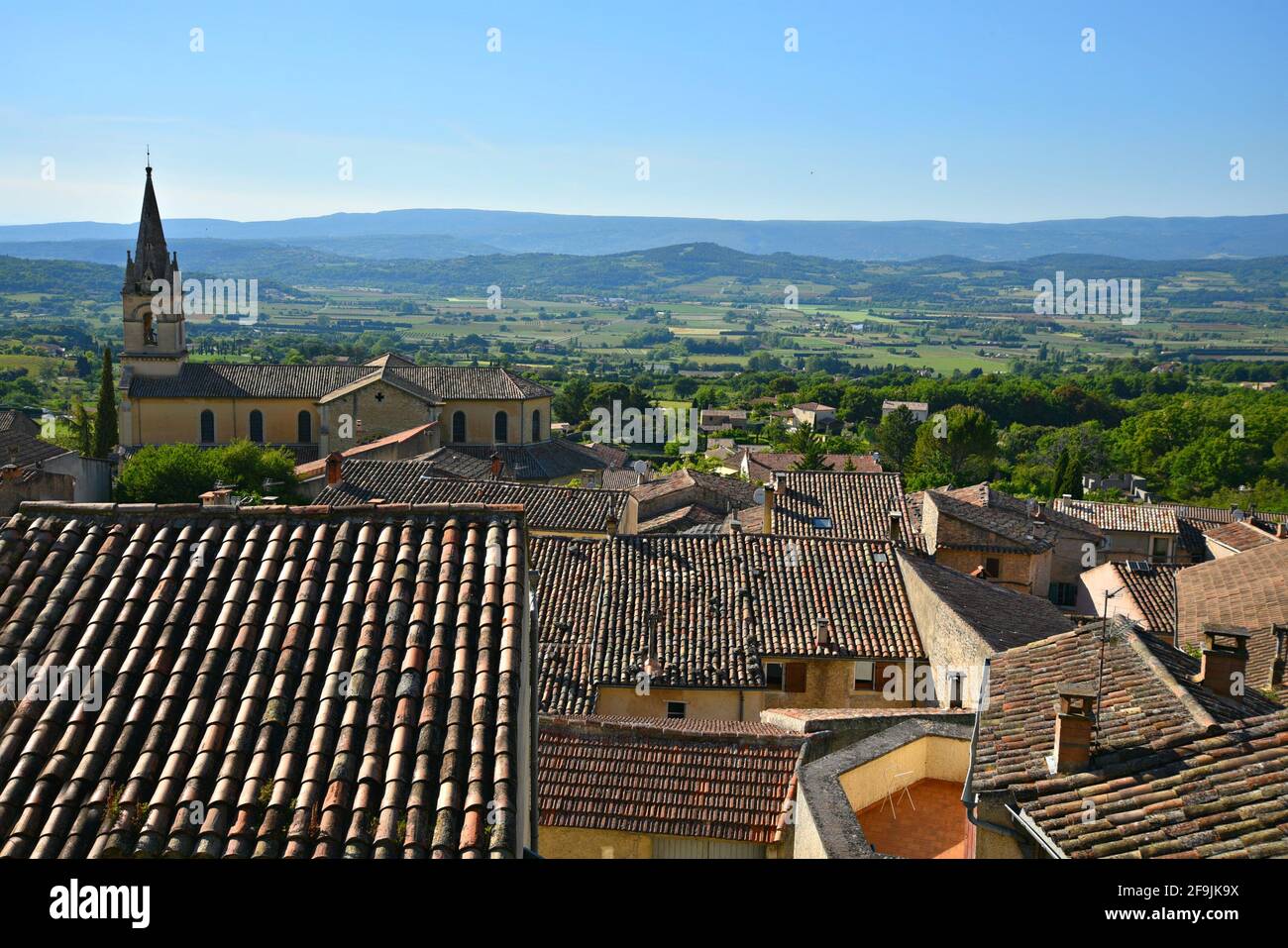 Landscape with scenic view of the Provençal style clay tile rooftop  rural houses in the picturesque village of Lourmarin in Vaucluse Provence France. Stock Photo