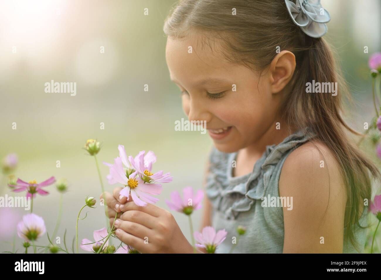 Portrait of cute little girl in park Stock Photo - Alamy