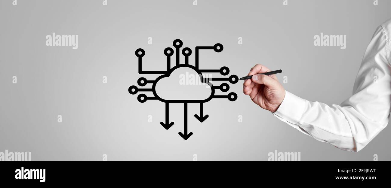 Businessman draws a download icon with computer processor chip on gray background. Cloud computing concept. Stock Photo