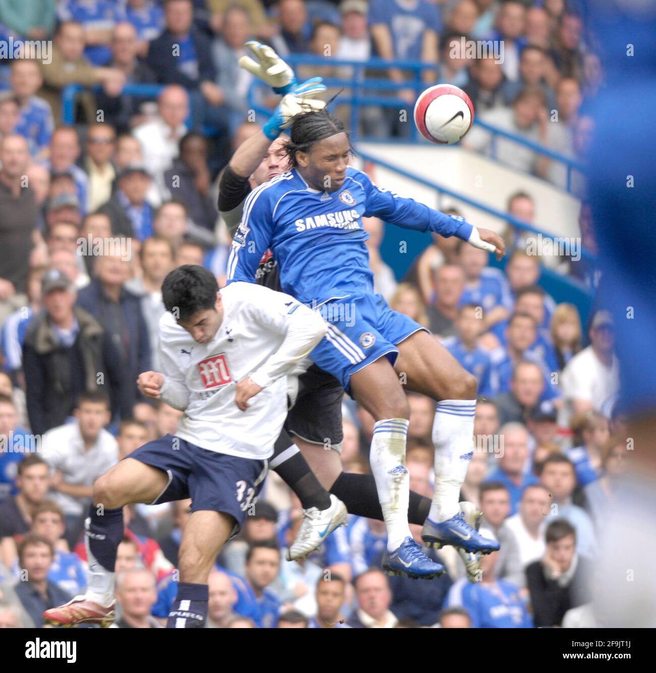 Didier Drogba and Paul Robinson collide in the air as both players challenge for the ball Stock Photo