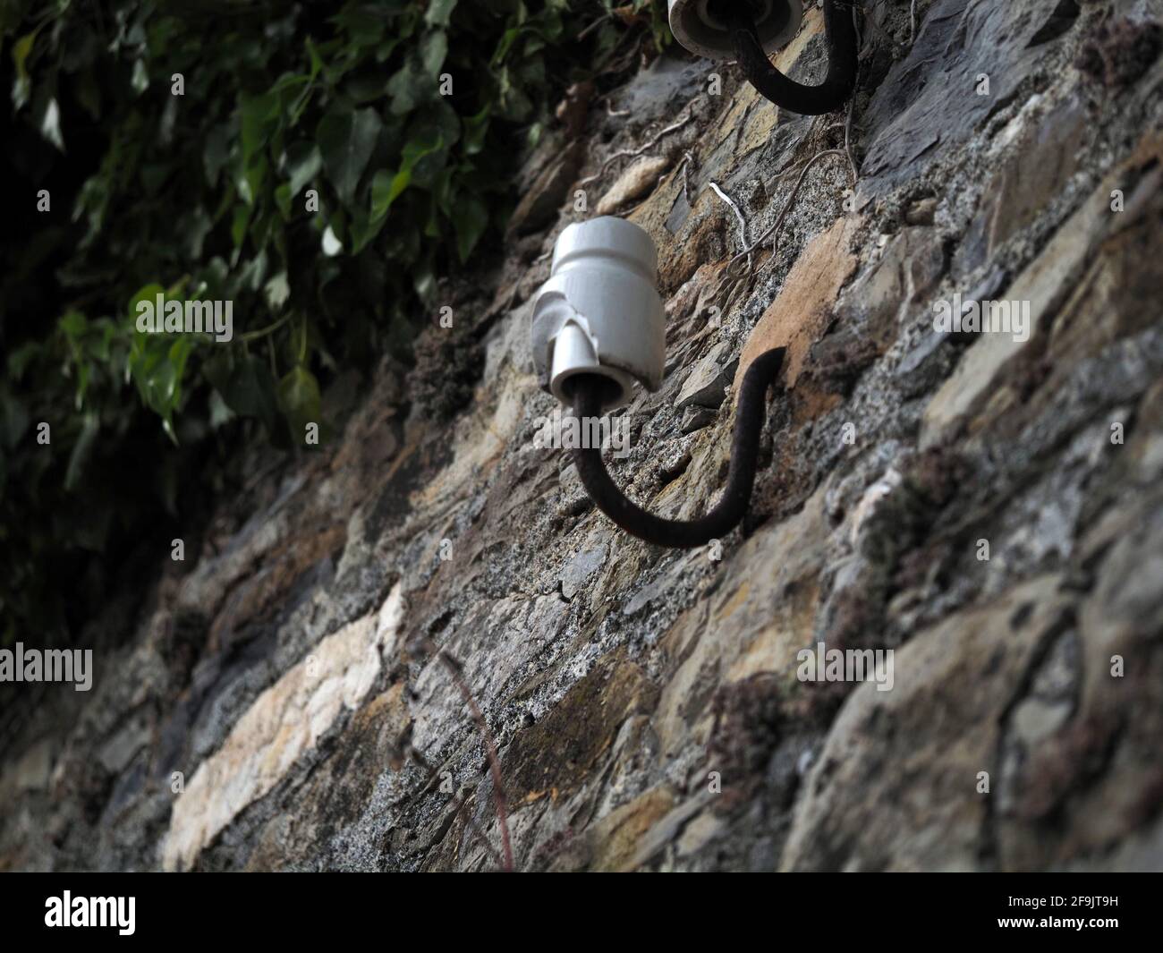 old ceramic telephone cable wire support detail Stock Photo - Alamy