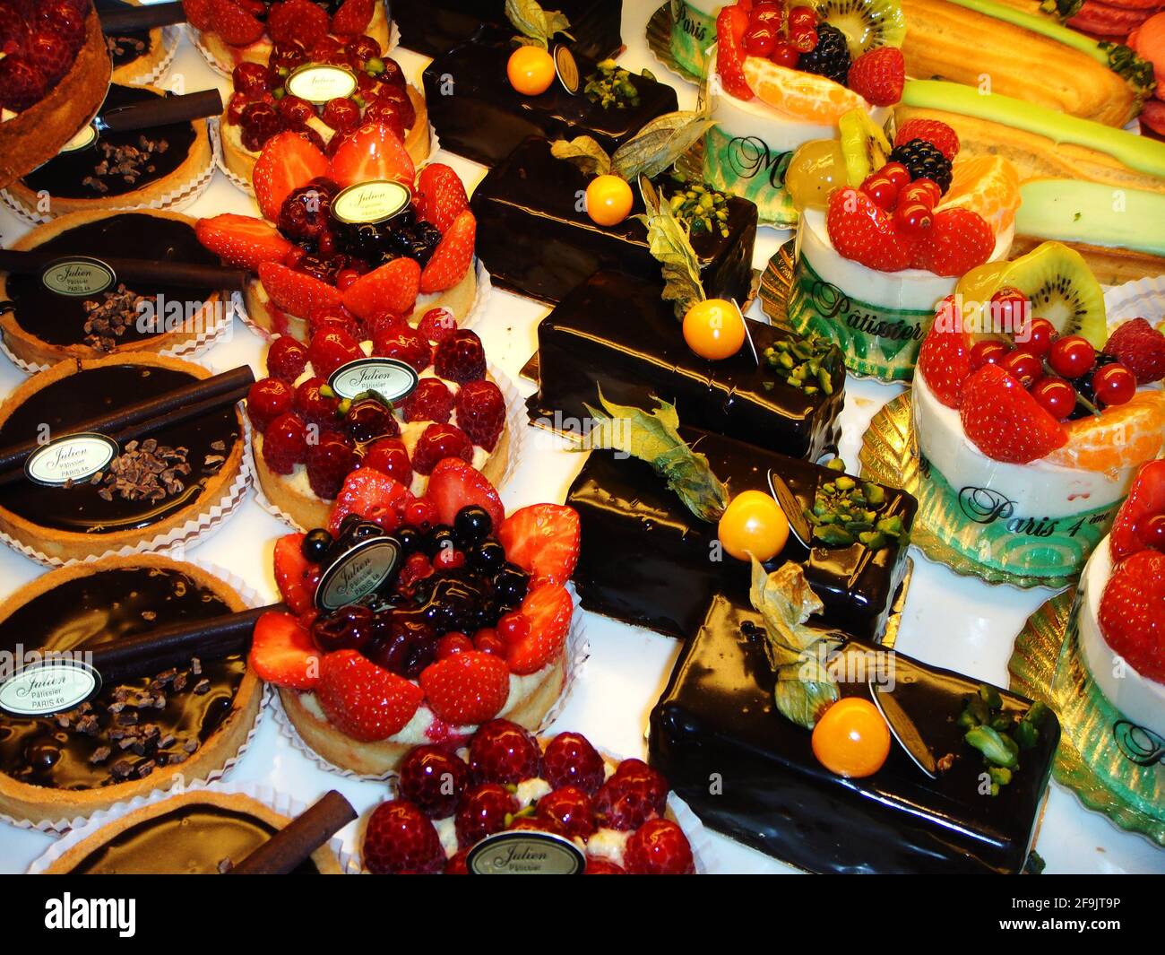 leckere Ausblicke ins Schaufenster einer pariser Patisserie, gefüllt mit köstlichen Obsttörtchen garniert mit Früchten, Schokolade und Karamell Stock Photo