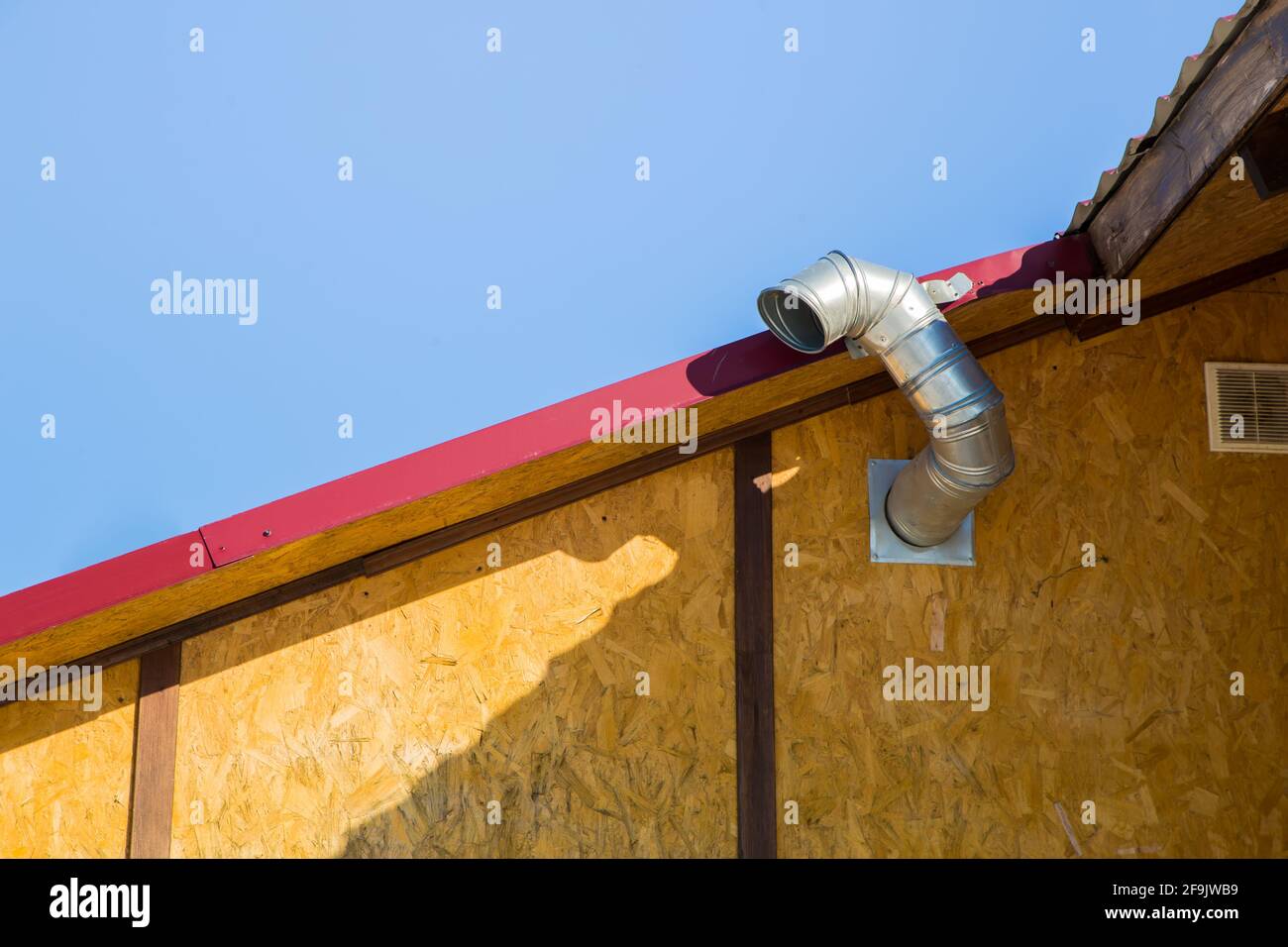 Chimney for exhausting smoke and polluted air in the wall against the