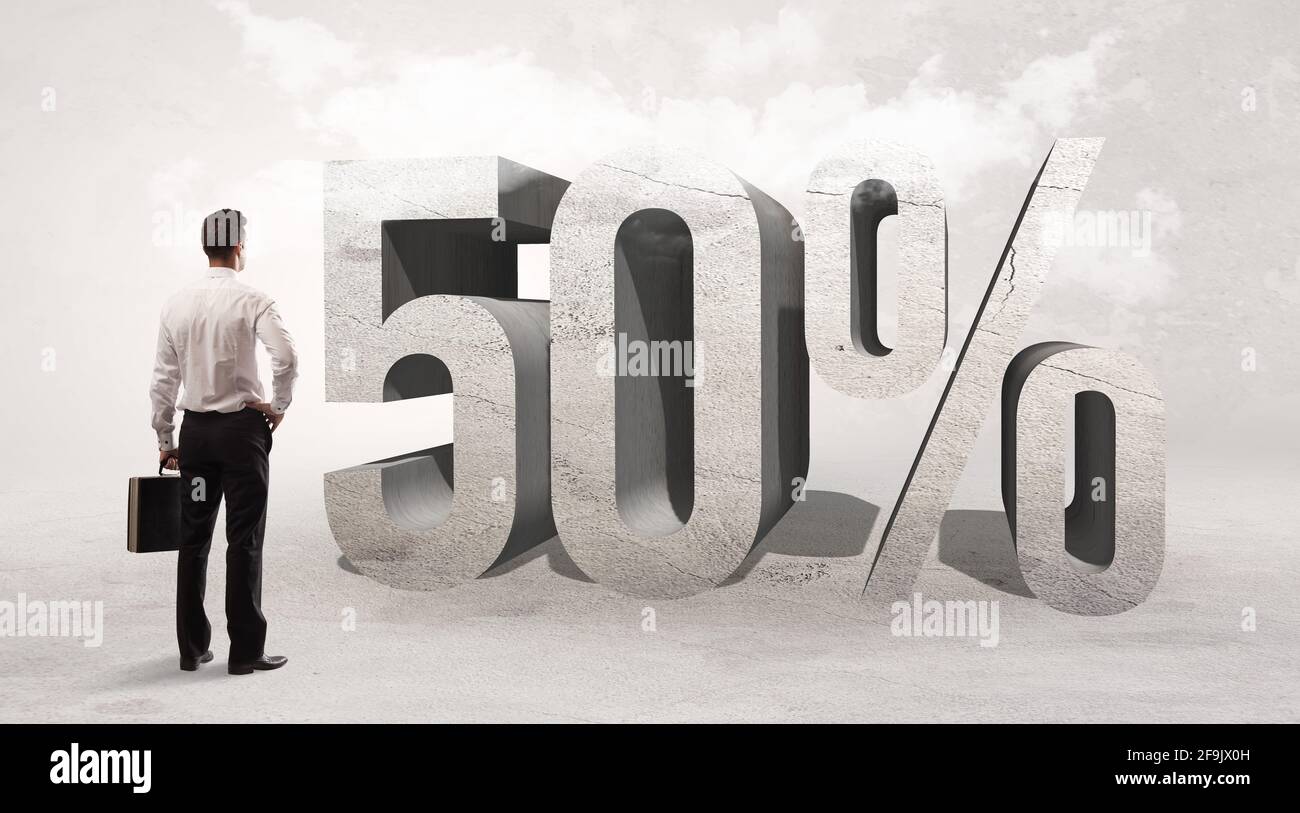 Rear view of a businessman standing in front of abbreviation concept Stock Photo Alamy