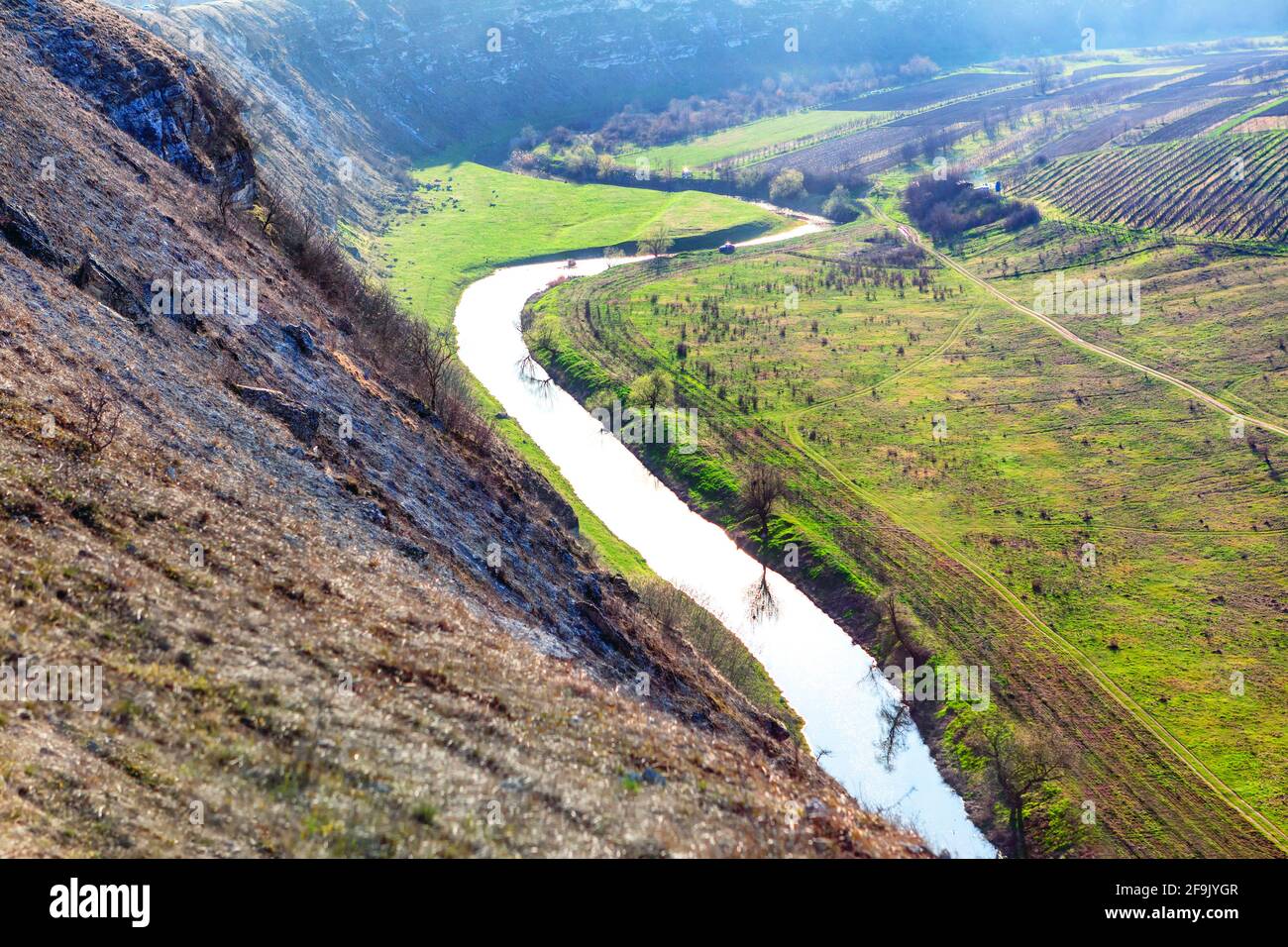 Green mountain valley with river . Panoramic view of riverside fields Stock Photo