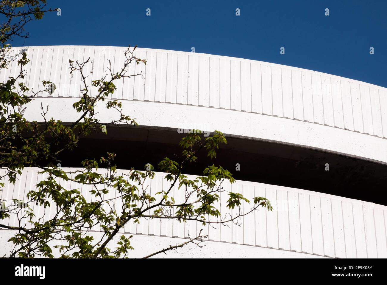 Kingston Upon Thames London UK, April 19 2021, White Curved Car Park Access Ramp Against A Clear Blue Sky With No People Stock Photo