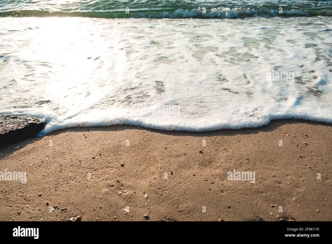 Close Up Wave Sand Beach Sea Foam. Closeup of sea wave with foam on ...