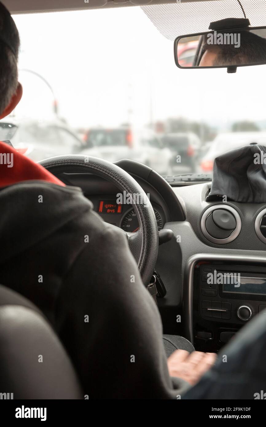 interior of a car, showing the steering wheel, mirror and dashboard of