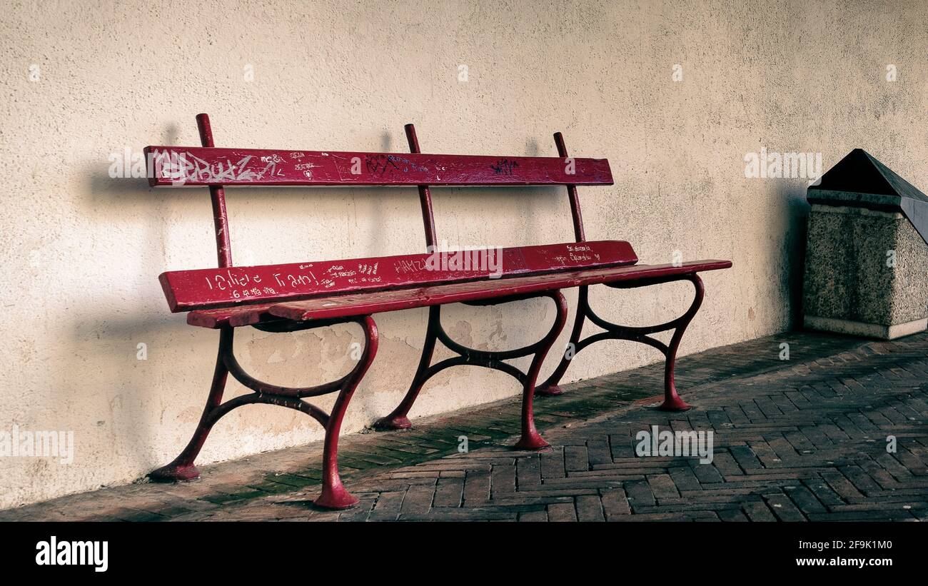 Vintage red bench under an Italian portico Stock Photo