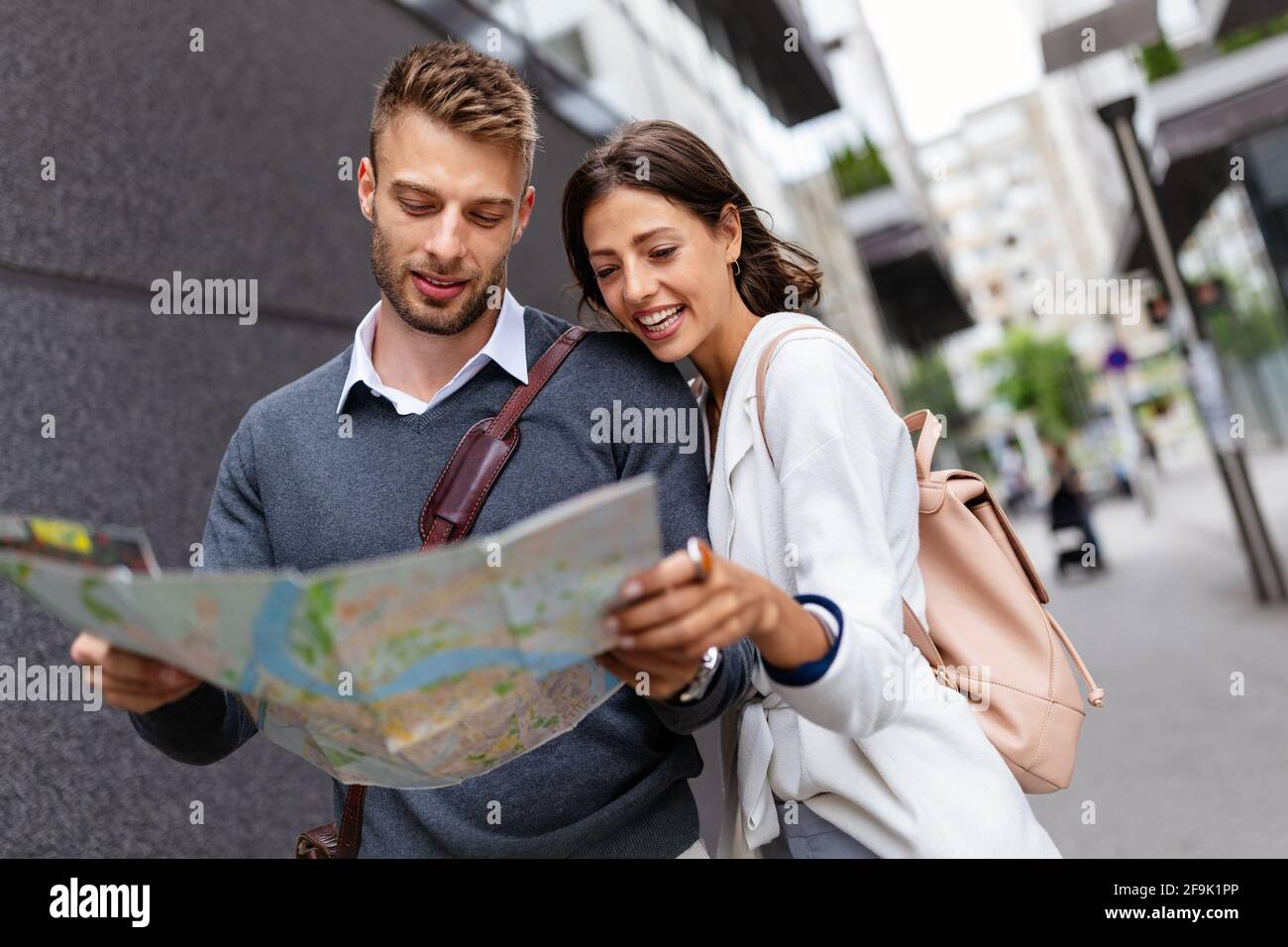 Happy young tourist couple walking street on vacation together Stock Photo