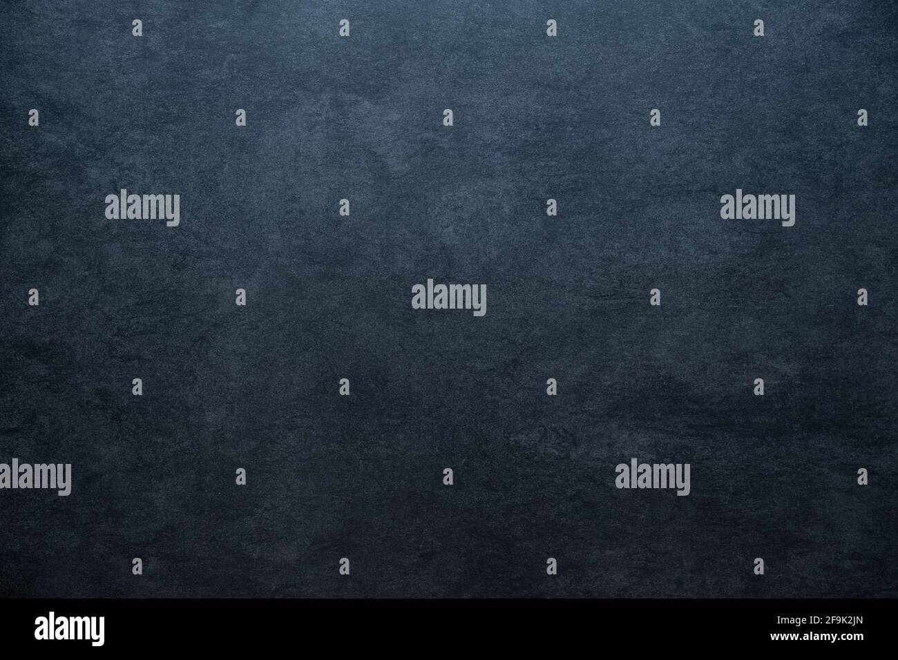 old blackboard concrete stone background texture with light gradient and copy space blue colored Stock Photo