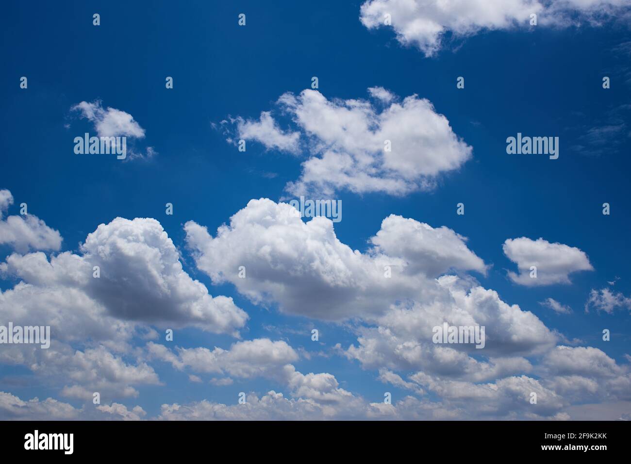 The blue sky with fluffy clouds Stock Photo - Alamy