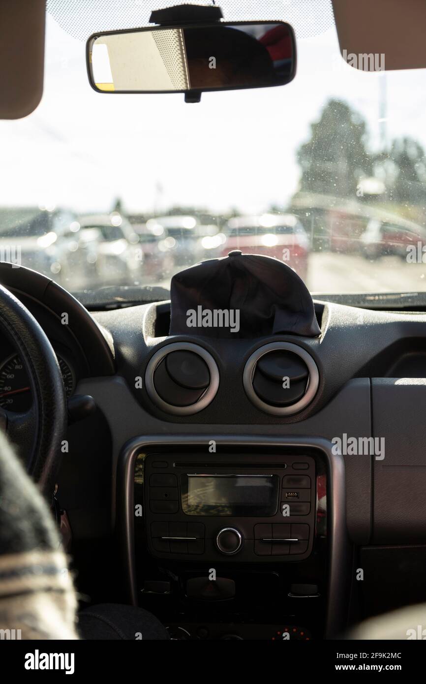 detail of the interior of a car, showing the steering wheel, mirror and