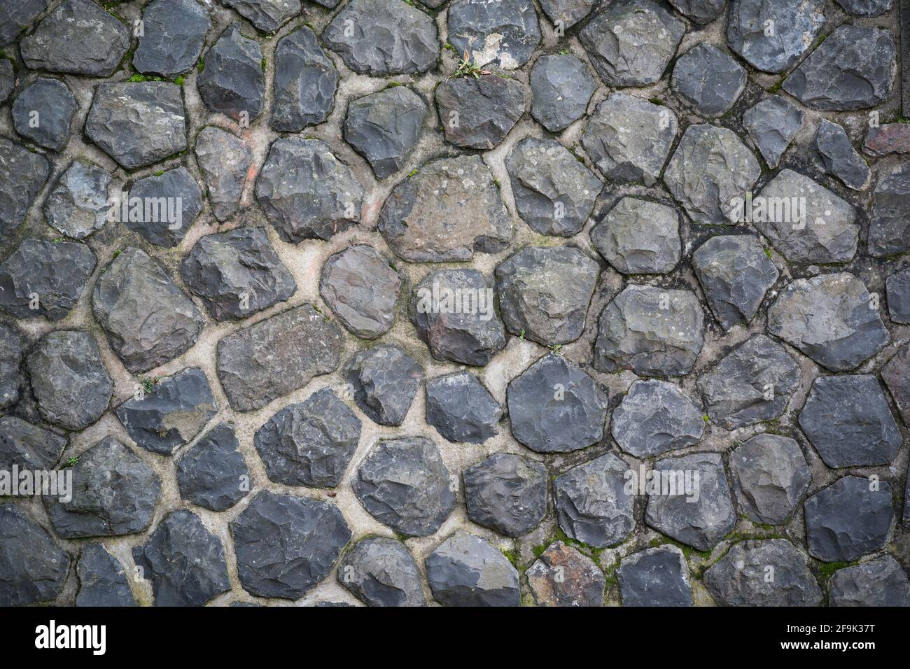 old dark paving stone background texture mural wall Stock Photo
