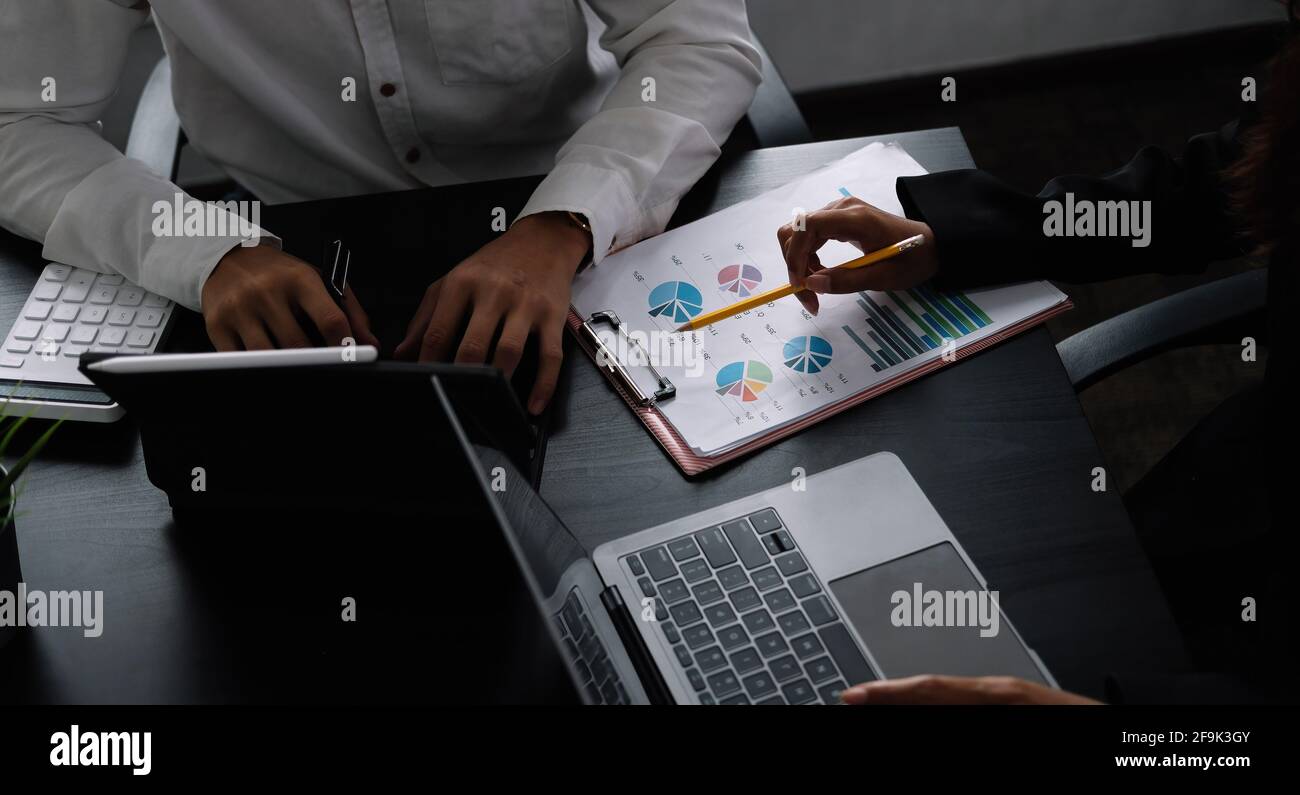 Two business teamwork calculating a valuation in workplace. Stock Photo