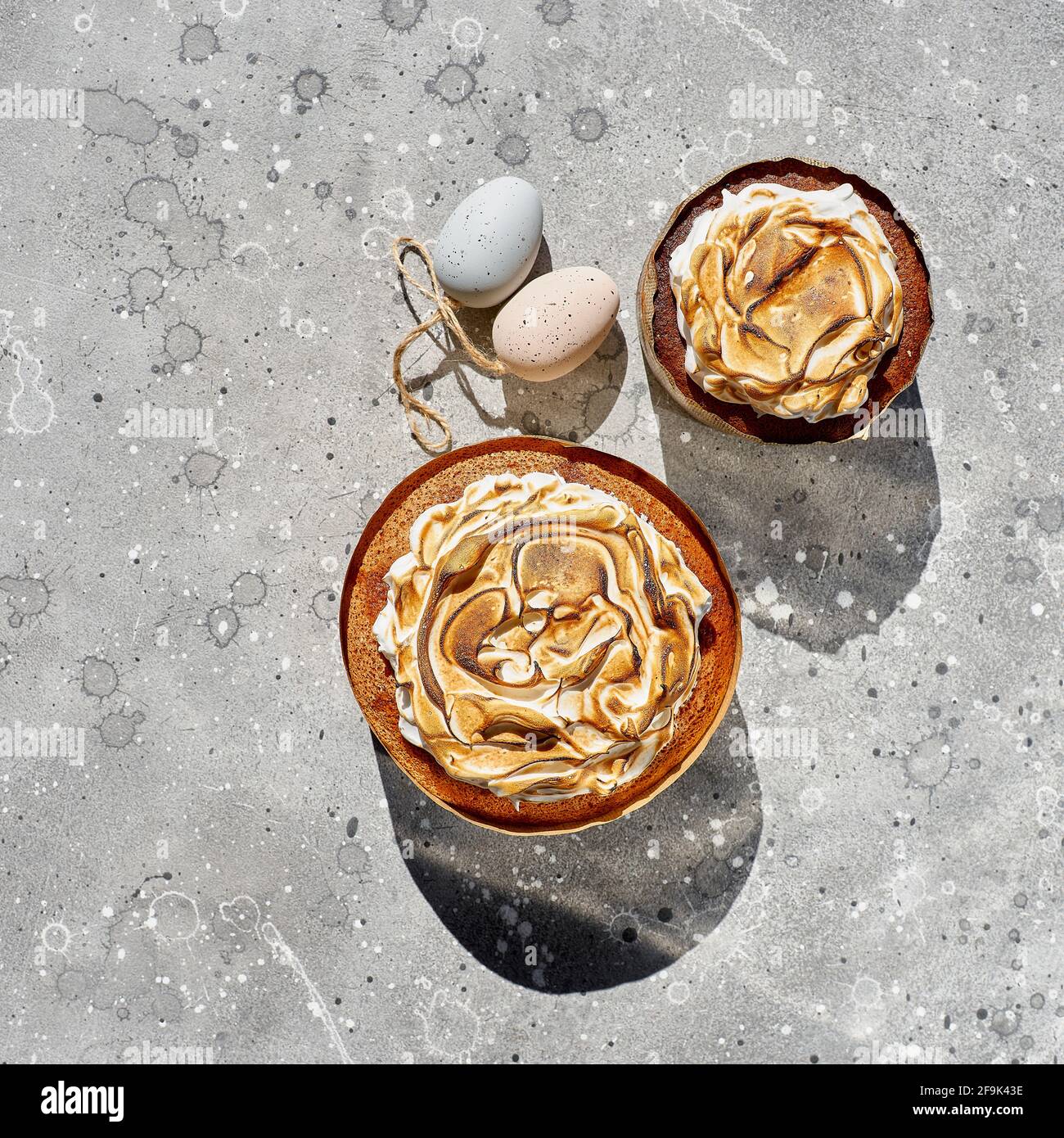 Flat lay composition with Easter cakes on a light stone background. Space for text. Easter Cake - Russian and Ukrainian Traditional Kulich Stock Photo