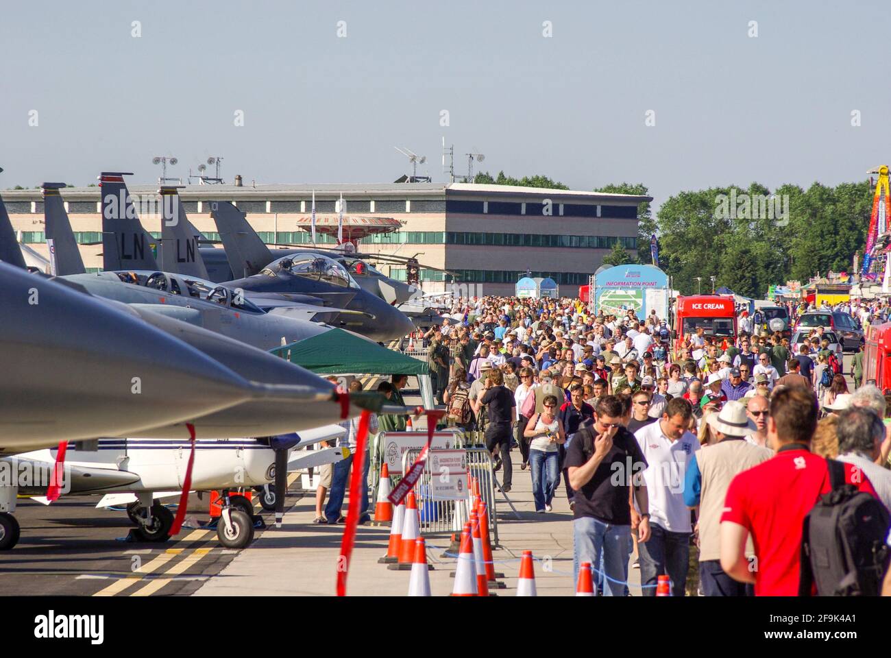 Crowds of people at the RAF Waddington Airshow 2009, with fighter jet planes on display. Packed public event. Sunny, summer event. Stock Photo