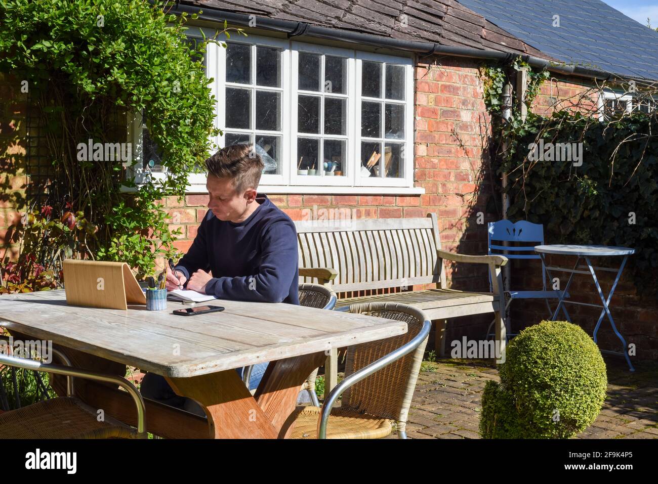 Man working from home remote working online in the garden Stock Photo ...